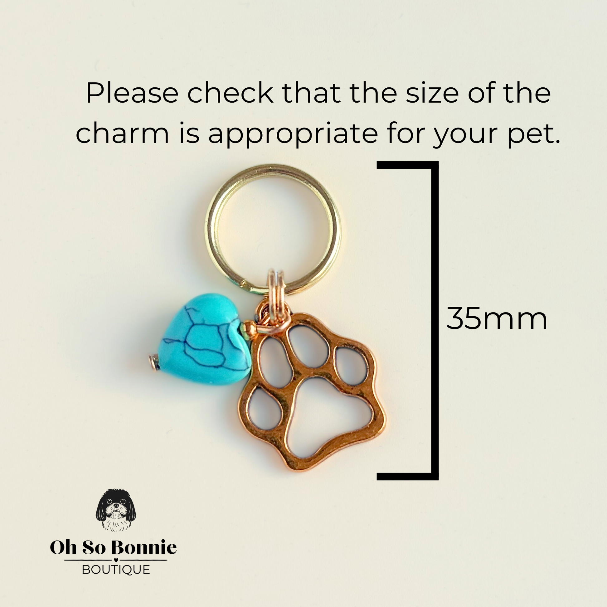 Crystal for dogs pet collar charm featuring a 10mm turquoise blue howlite heart shaped bead and a brass gold coloured paw print tag. Pictured showing dimensions.  