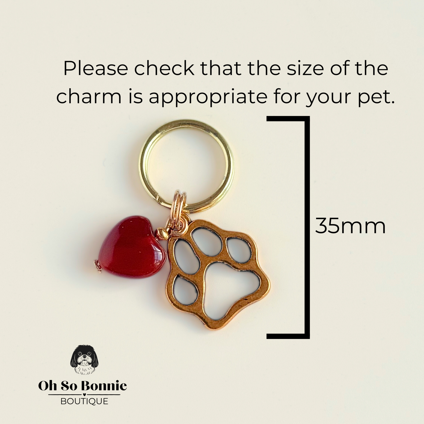 Crystal for dogs pet collar charm featuring a 10mm red carnelian heart shaped bead and a brass gold coloured paw print tag. A stone for confidence, vitality and motivation. Picture shows dimensions.