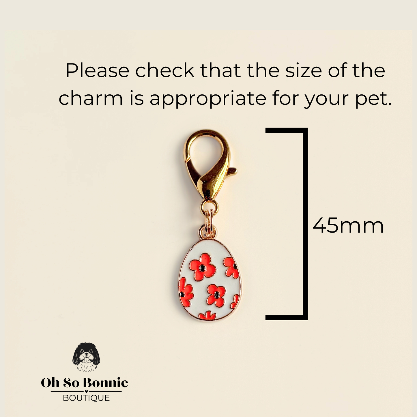 White with red flowers Easter egg enamel dog collar charm that easily attaches to collars and harnesses with a gold plated lobster clasp. Picture showing dimensions.￼