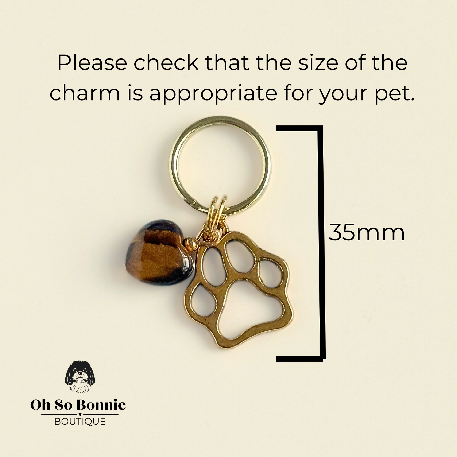 Crystal for dogs pet collar charm featuring a 10mm tigers eye heart shaped bead and a brass gold coloured paw print tag. Pictured showing dimensions.