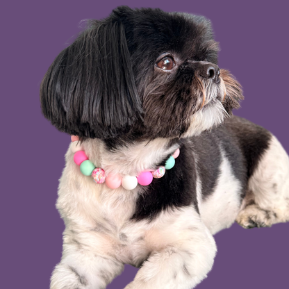 Silicone beaded dog necklace made with 15mm round beads in pink, green, white and a floral flowers print. On a strong, elastic stretch cord. Pictured been modelled by Bonnie.￼