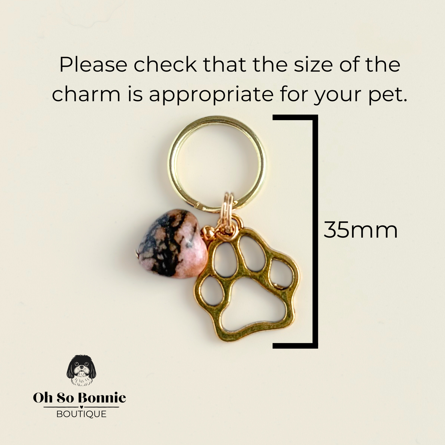 Crystal for dogs pet collar charm featuring a 10mm rhodonite heart shaped bead and a brass gold coloured paw print tag. Picture showing the dimensions.￼
