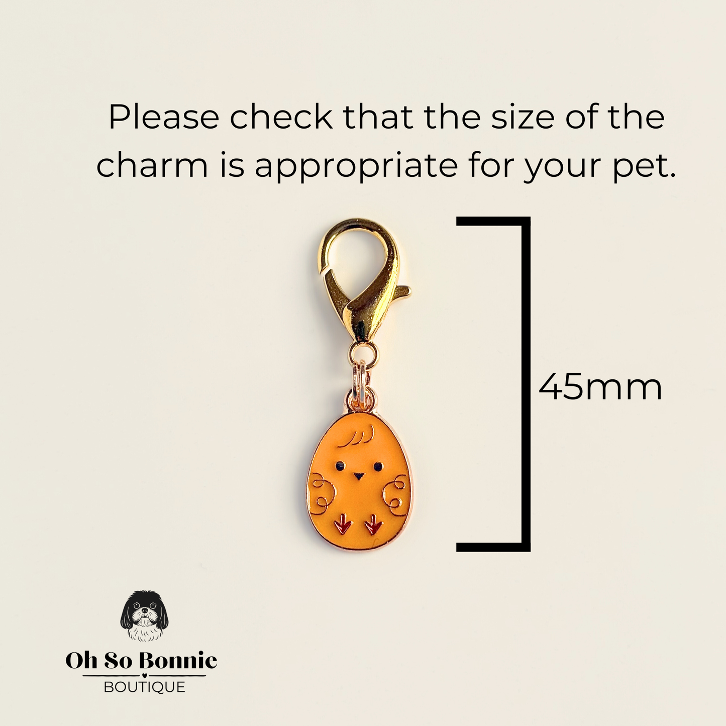 Yellow chick Easter egg enamel dog collar charm that easily attaches to collars and harnesses with a gold plated lobster clasp. Pictured showing the dimensions.