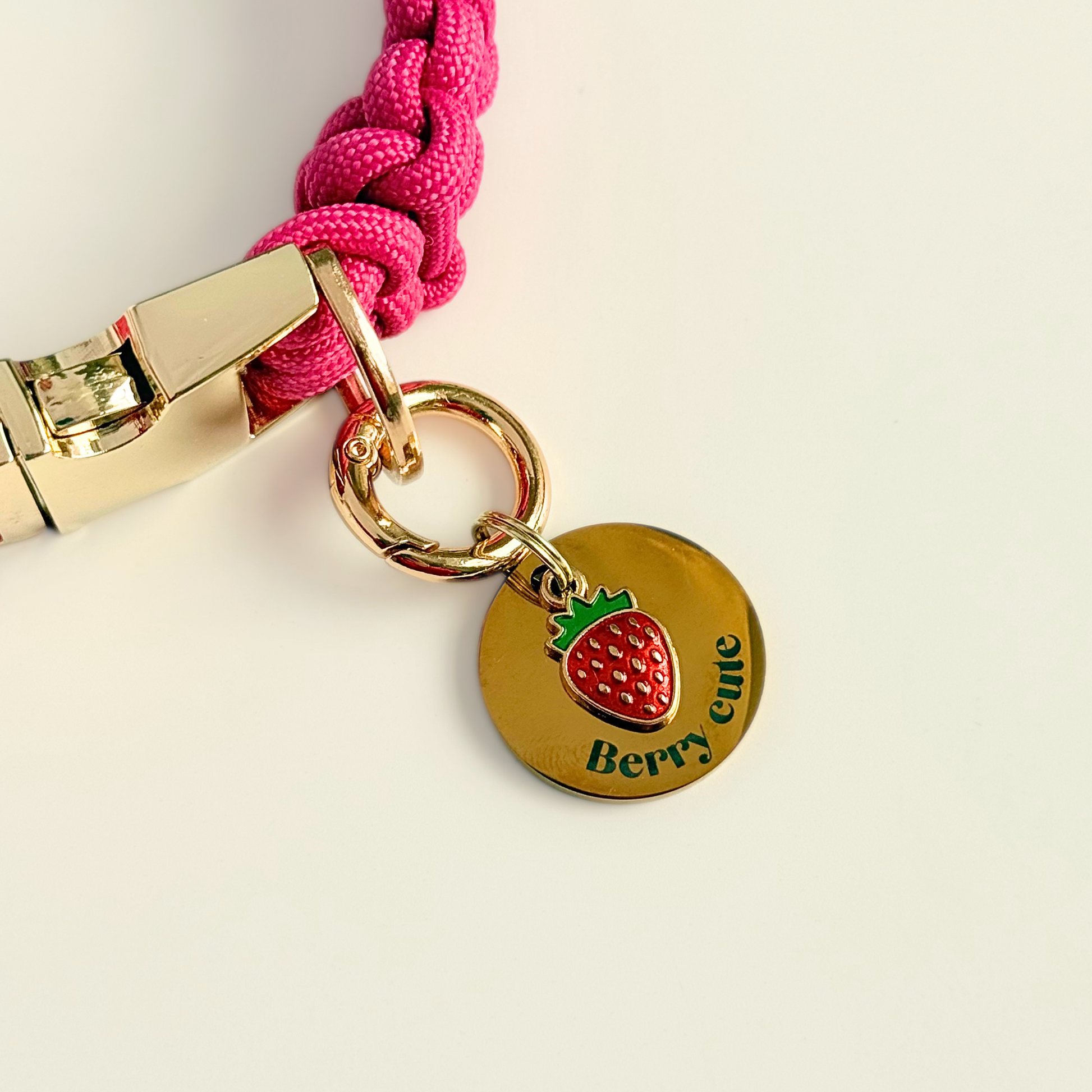 Gold red strawberry dog collar ID tag, Enamel fruit charm with dog name and address details. easily clips onto collar or harness. Pictured attached to a pink paracord dog collar.