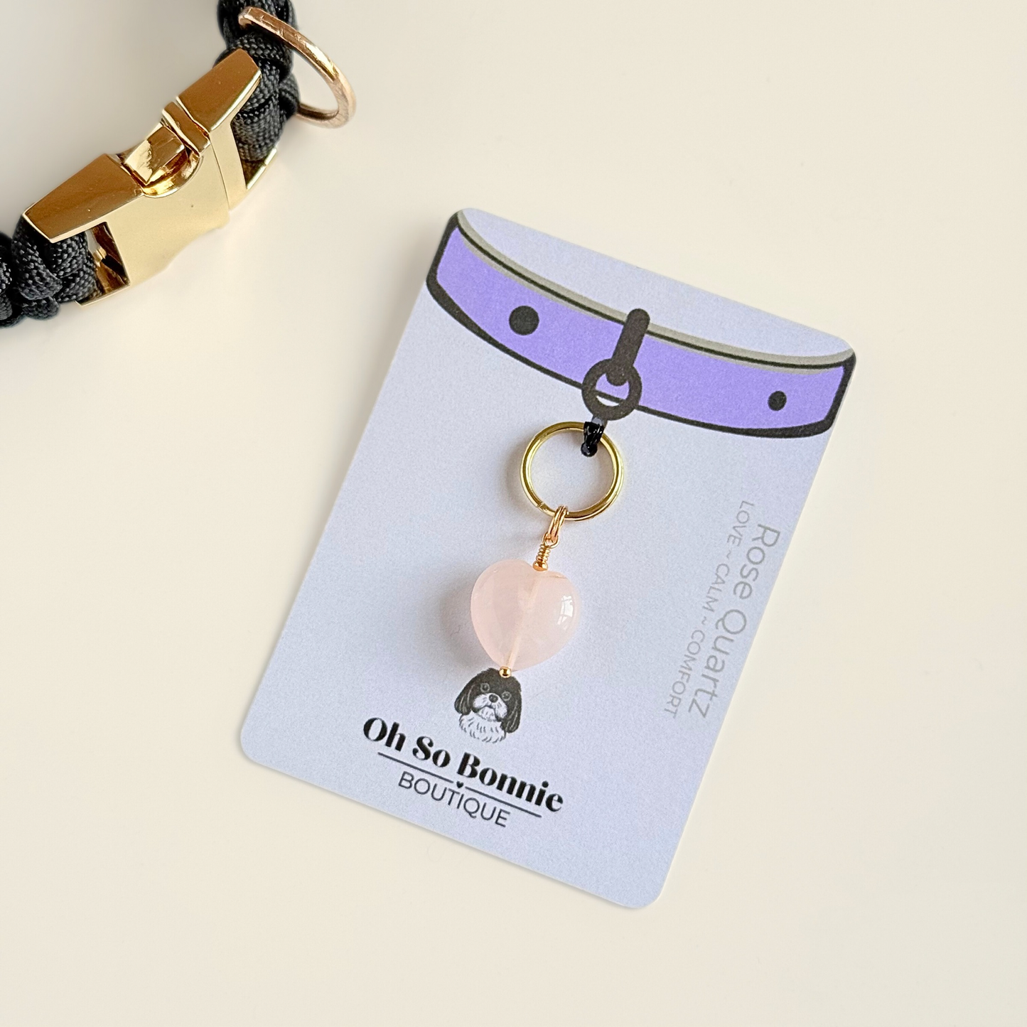 Handmade dog collar charm featuring a 15mm pink rose quartz natural gemstone crystal bead. Hung on a gold plated brass split ring that attaches onto your pet collar. Rose quartz can help pets with love, comfort and calming. Pictured on the display card.