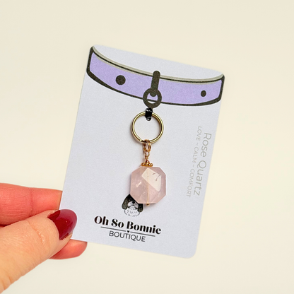 Handmade dog collar charm featuring a 17mm pink rose quartz natural gemstone faceted square crystal bead. Hung on a gold plated brass split ring with a daisy gold spacer bead that attaches onto your pet collar. Rose quartz can help pets with love, comfort and calming. Pictured on the display card.