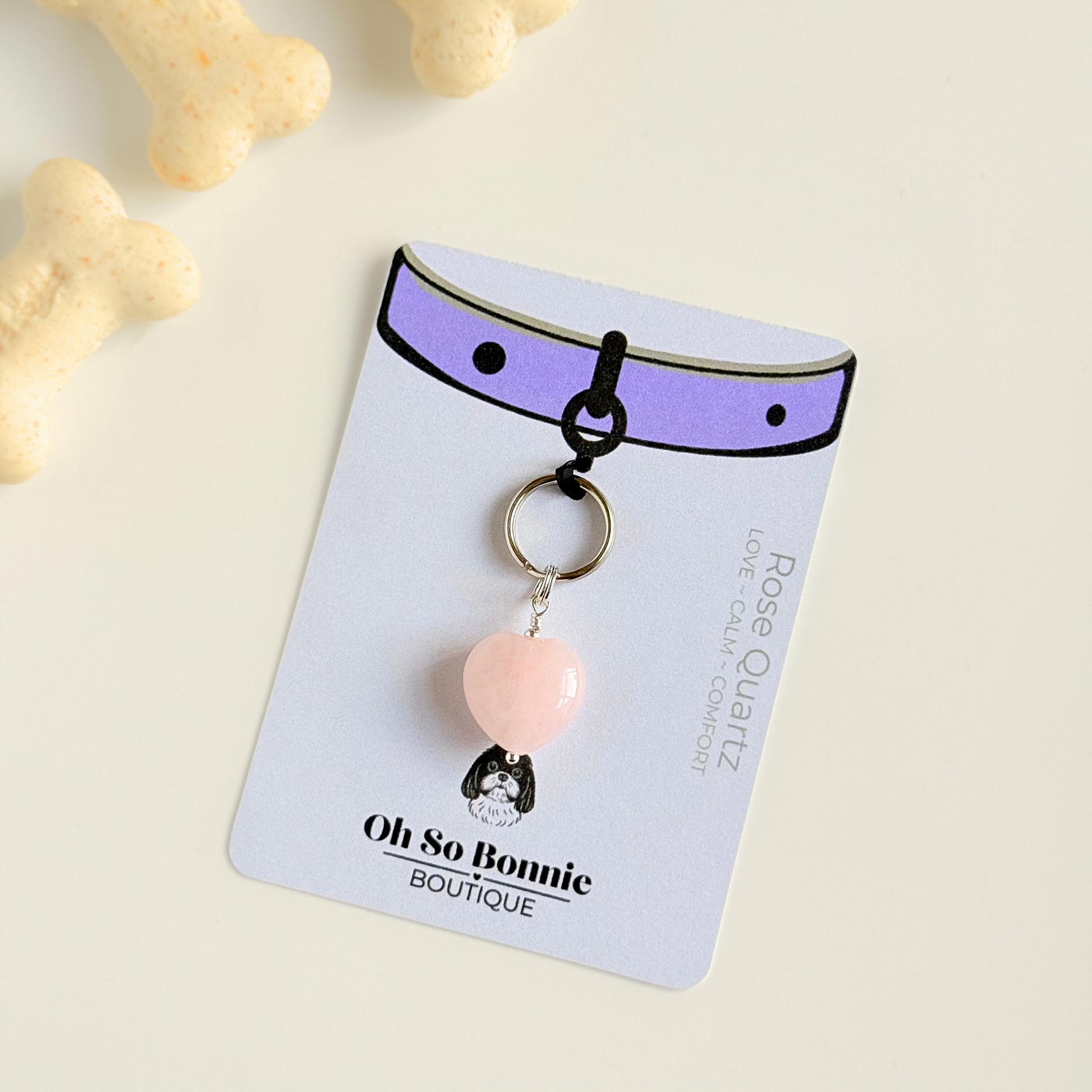 Handmade dog collar charm featuring a 15mm pink rose quartz natural gemstone crystal bead. Hung on a silver plated brass split ring that attaches onto your pet collar. Rose quartz can help pets with love, comfort and calming. Pictured on the display card.