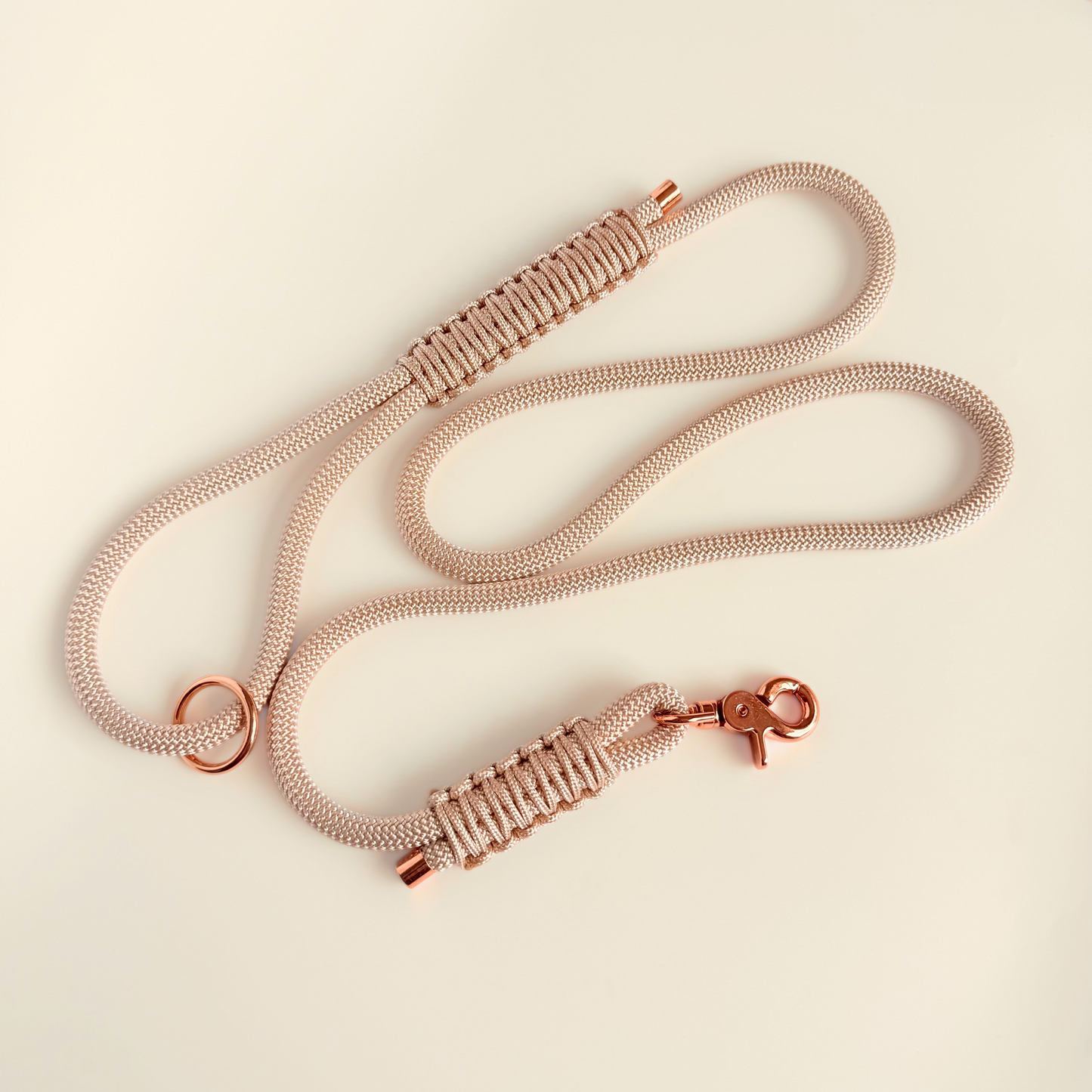 Custom made ‘pearl rose’ beige/champagne coloured nylon rope dog lead with choice of metal hardware. Four lengths available. Easy strong grip handle. Pictured laid out on a cream background.