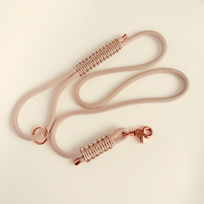 Custom made ‘pearl rose’ beige/champagne coloured nylon rope dog lead with choice of metal hardware. Four lengths available. Easy strong grip handle. Pictured laid out on a cream background.