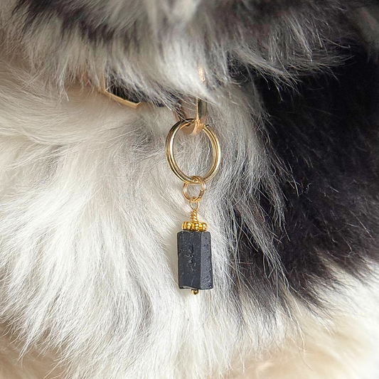 Crystal dog collar charm featuring a raw black tourmaline natural bead with gold plated accents. Featuring a brass split ring for easy attaching to your pet’s collar. Pictured attached to Bonnie’s collar.