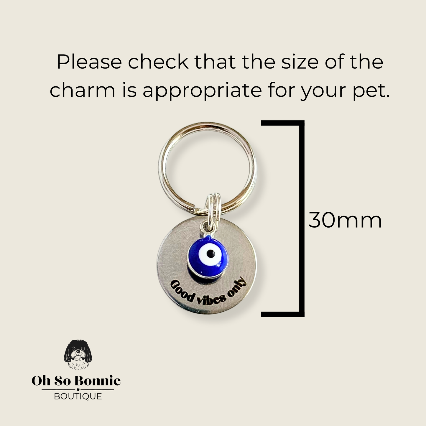 Silver plated brass and stainless steel 15mm dog collar charm with ID tag. Personalised custom identification tag with a small, blue Turkish Evil Eye charm, on a 15mm silver split ring. Engraved with the words ‘Good vibes only’ on the front. Pictured against a cream background showing the dimensions of the charm.