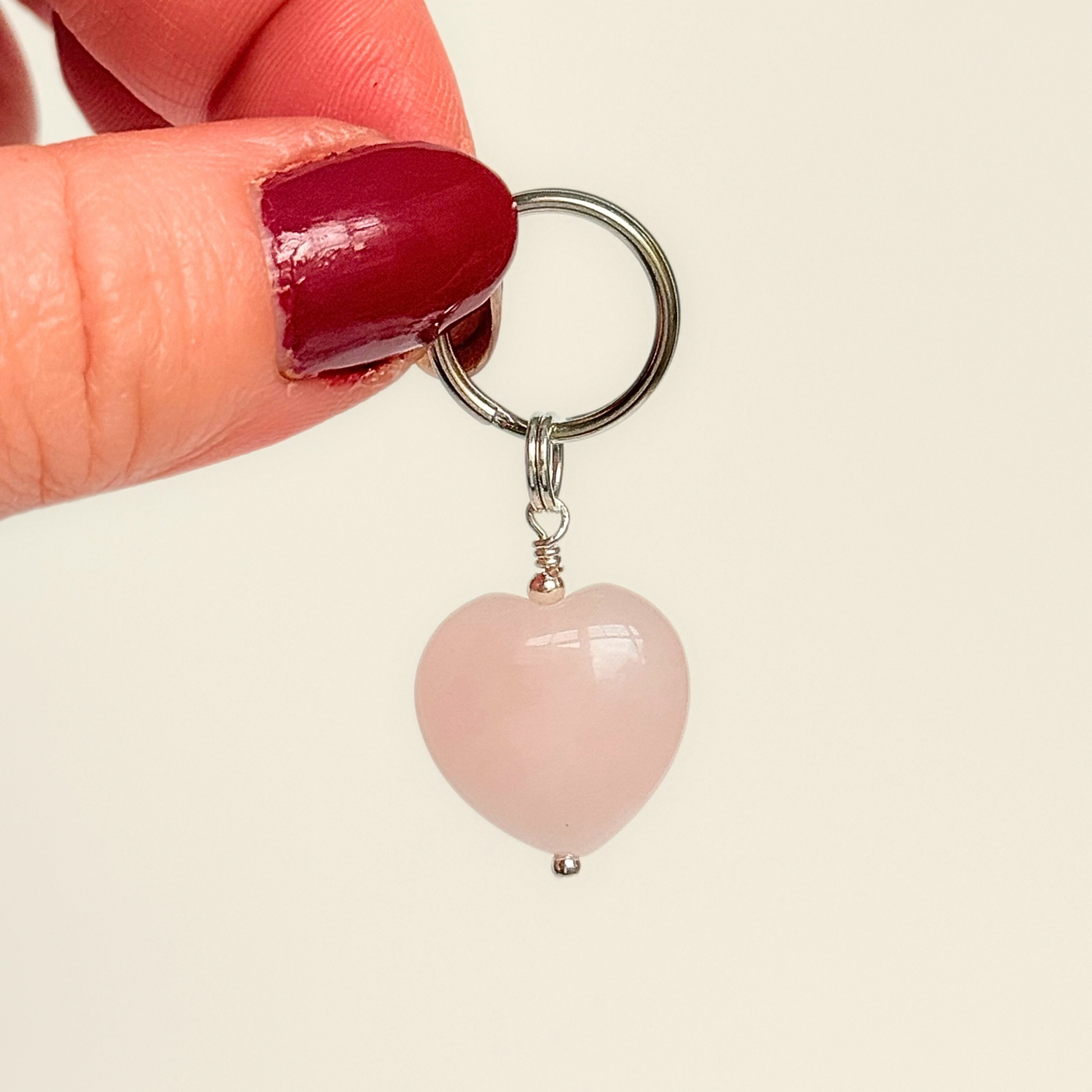 Handmade dog collar charm featuring a 15mm pink rose quartz natural gemstone crystal bead. Hung on a silver plated brass split ring that attaches onto your pet collar. Rose quartz can help pets with love, comfort and calming.
