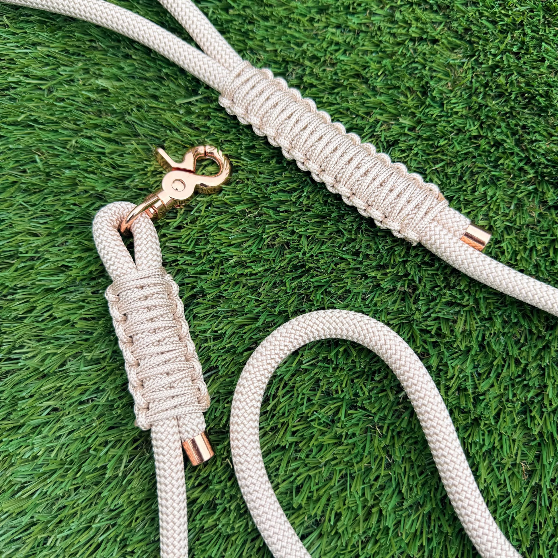 Custom made ‘pearl rose’ beige/champagne coloured nylon rope dog lead with choice of metal hardware. Four lengths available. Easy strong grip handle. Close up picture on the lawn.