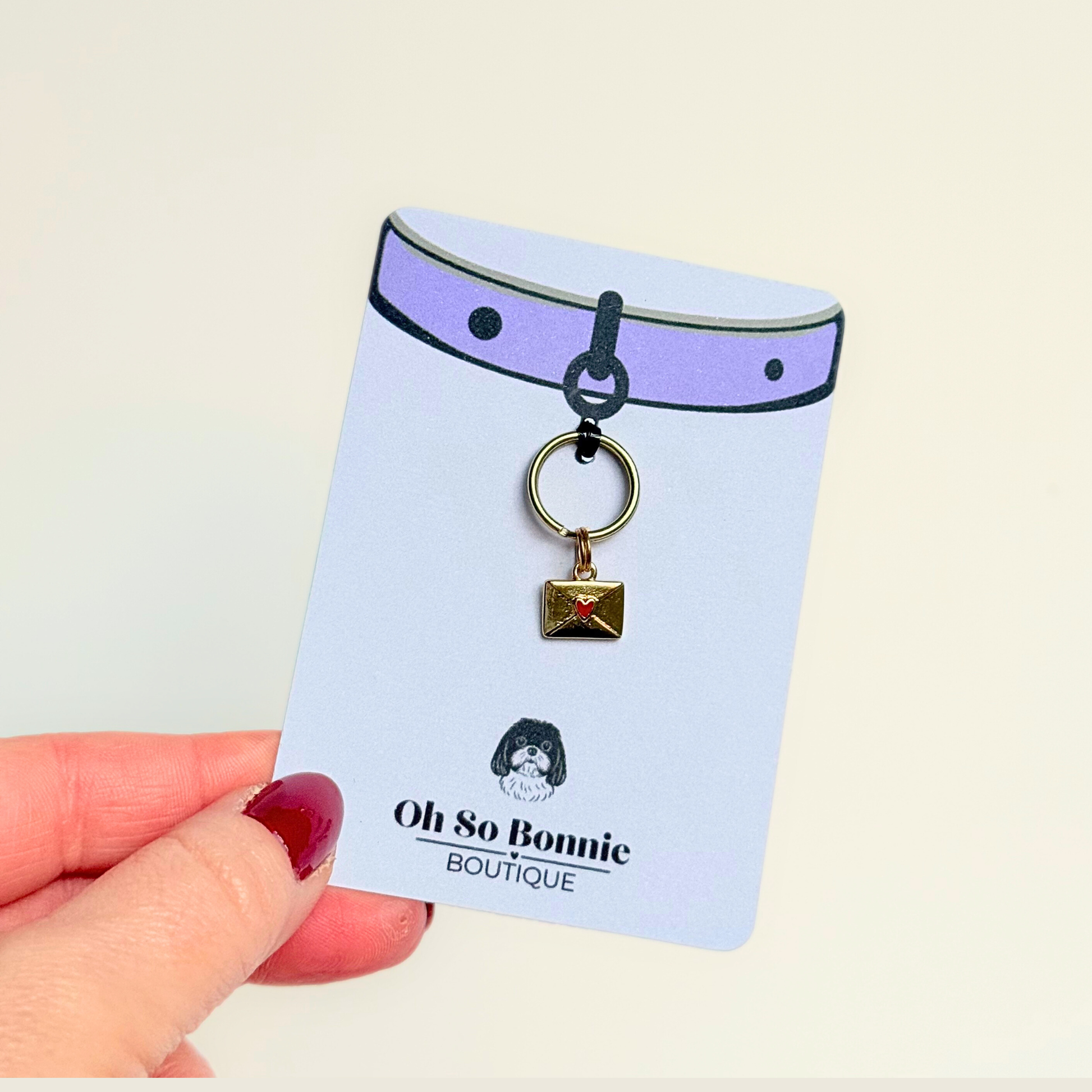 Gold plated brass envelope dog collar charm featuring a red enamel heart. Pictured on the display card.￼