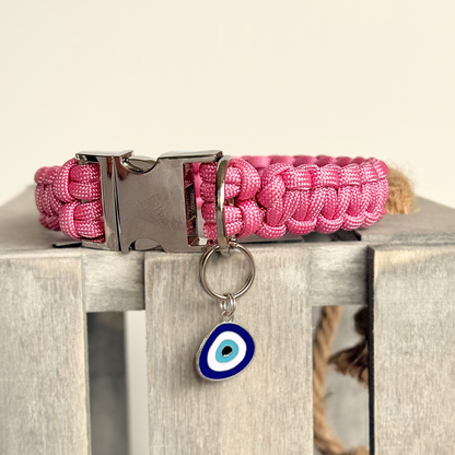Silver plated blue turkish evil eye dog collar charm, for protection, security and grounding, 35mm easy to attach to pet collars. Picture shows the tag attached to a pink paracord dog collar.