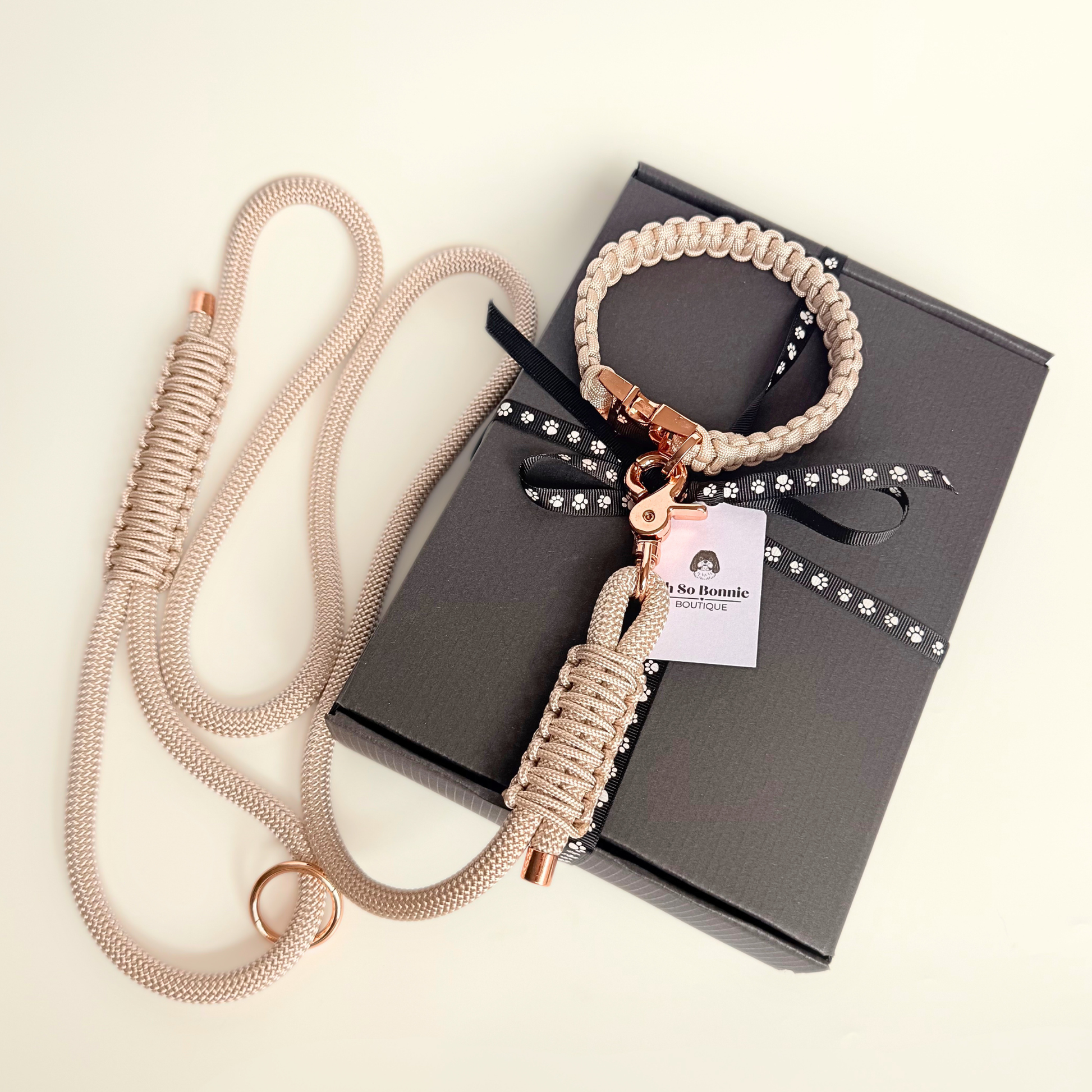 Custom made beige nylon rope dog collar set with matching paracord braided dog collar. Picture shows rose gold hardware option on top of the gift box