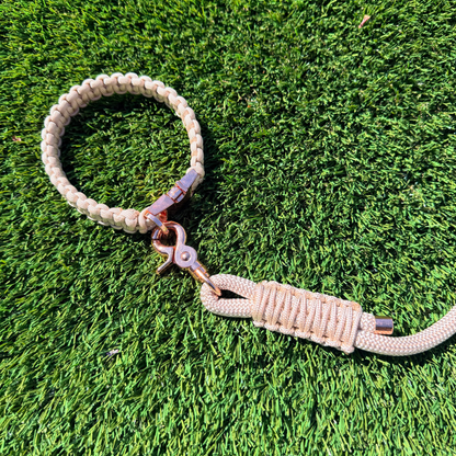 Custom made beige  paracord braided dog collar. Picture shows rose gold hardware option close up on lawn