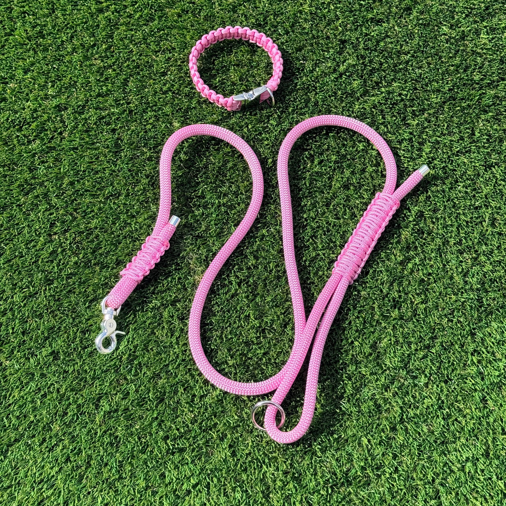 Custom made pink nylon rope dog collar set with matching paracord braided dog collar. Picture showing full set from above, on the lawn.