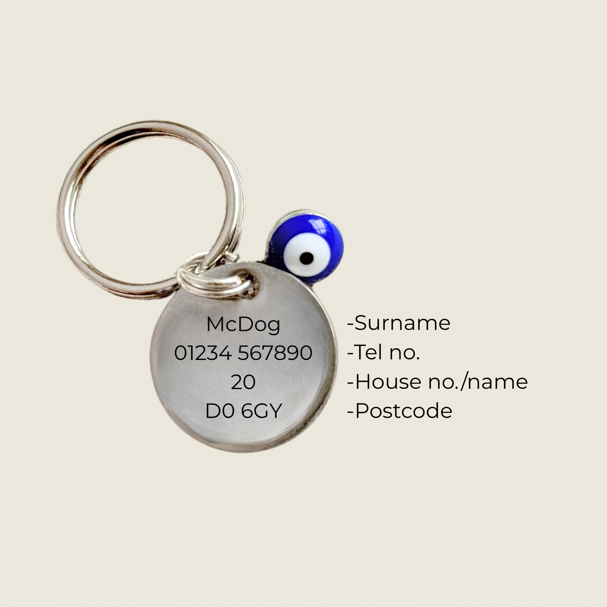 Silver plated brass and stainless steel 15mm dog collar charm with ID tag. Personalised custom identification tag with a small, blue Turkish Evil Eye charm, on a 15mm silver split ring. Engraved with the words ‘Good vibes only’ on the front. Pictured showing the personalisation on the back.