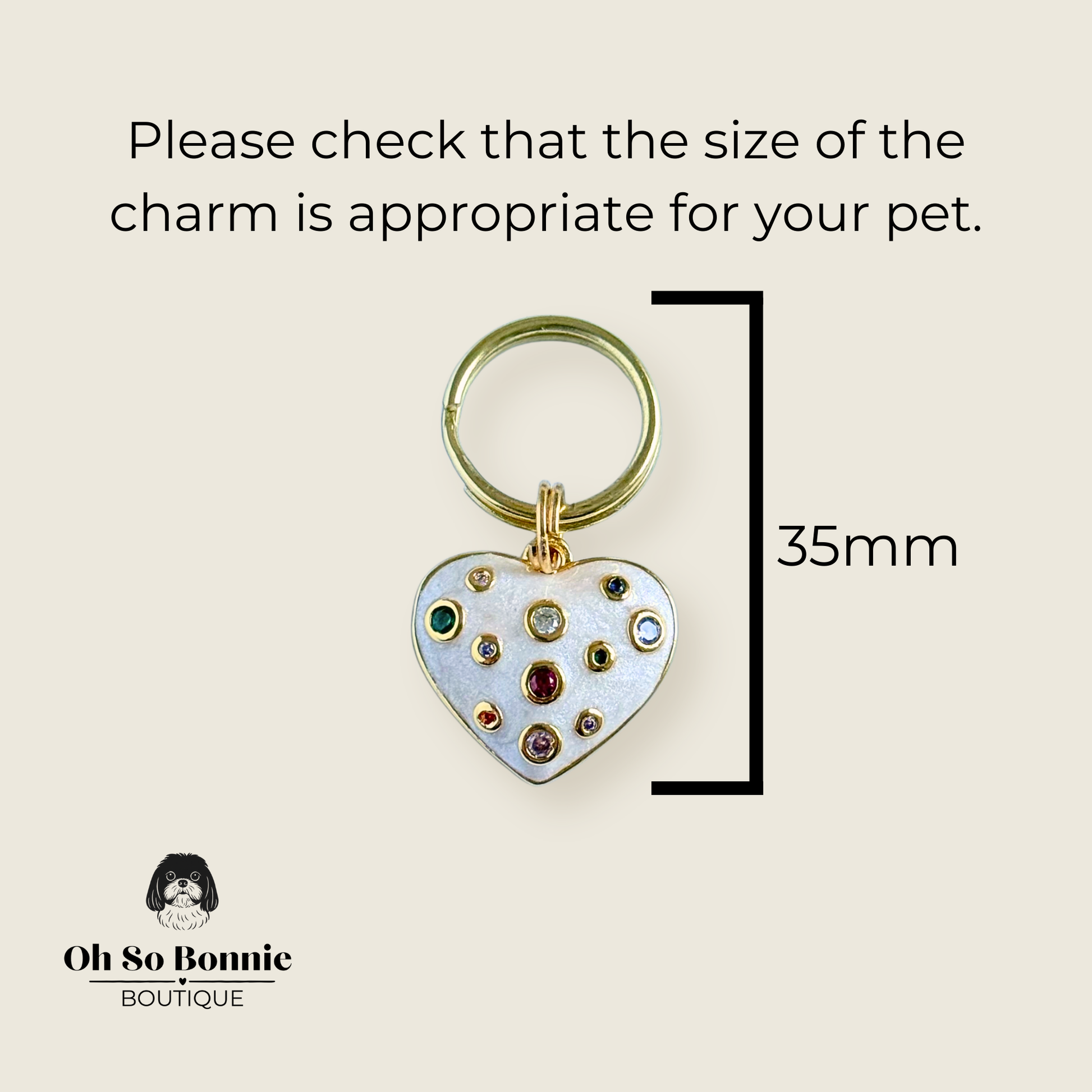 Heart shaped cream / off white pearlescent coloured enamel and brass pet collar charm featuring a selection of multicoloured cubic zirconia stones. Pictured against a cream background showing the dimensions of the charm.