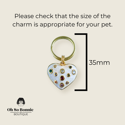 Heart shaped cream / off white pearlescent coloured enamel and brass pet collar charm featuring a selection of multicoloured cubic zirconia stones. Pictured against a cream background showing the dimensions of the charm.